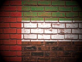 Old brick wall UAE flag