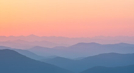 Obraz premium Scenic mountain range at sunset with layers of peaks and a colorful sky, creating a serene vista
