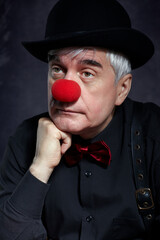 Dramatic portrait of a sad clown against a dark background