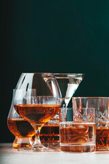 Strong alcoholic drinks set. Spirits, liqueurs, distillates etc. in glasses. Drink background...