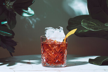 Bourbon alcoholic cocktail drink with bitters, Italian herbal liqueur and lemon zest