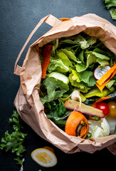Zero waste concept. Food trash in recyclable paper bag for compost. Sustainable lifestyle, plastic...