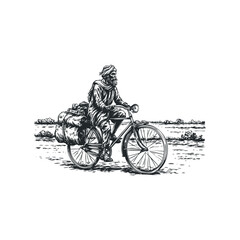 Obraz premium Indian man riding bicycle loaded with goods through rural landscape