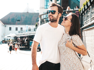 Smiling beautiful woman and her handsome boyfriend. Woman in casual summer clothes. Happy cheerful...