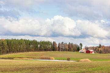 Farm on a field in a cultivated landscape at autumn