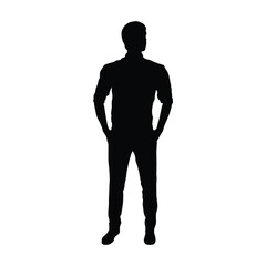 Silhouette of a man standing with his hands casually in his pockets and wearing a collared shirt with the sleeves rolled up.