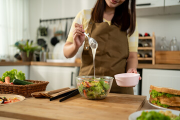 Close up of woman cooking healthy foods in kitchen in morning at home. 
