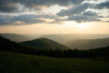 Beautiful morning view of mountains at sunrise. Amazing mountain landscape with colorful vivid sunset on the cloudy sky, natural outdoor travel background. Stunning morning mountain.