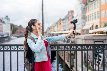 Asian woman traveler use camera record vlog while traveling in the city. 