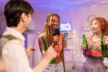 Group of diverse Generation Z friends enjoying a party in a cozy house. 