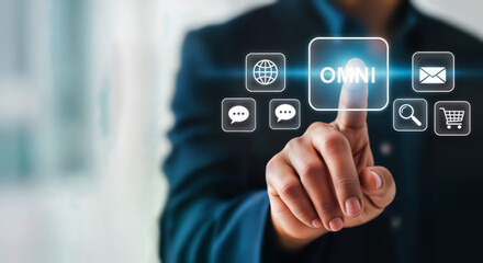 Businessman pressing a glowing button with the word omni, surrounded by icons representing digital communication and commerce, symbolizing an omnichannel strategy