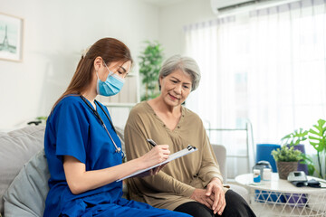 Asian beautiful caregiver examine senior woman patient at nursing home. 