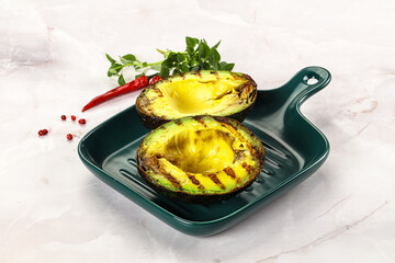 Sliced fresh avocado on the grill