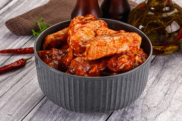 Raw marinated buffalo chicken wings