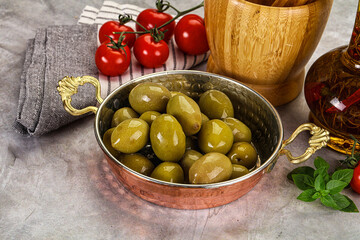 Big green marinated olives in the bowl