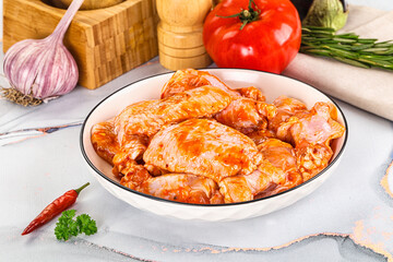 Raw marinated uncooked chicken wings