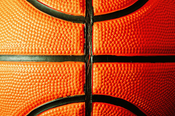 Close-up detailed macro texture of an official orange leather basketball. Streetball and hoops....