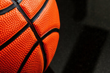 A close-up shot captures the texture and details of an orange basketball. Showcases the raised...