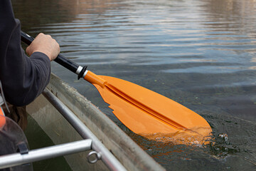 Close up of man holding canoe paddle.