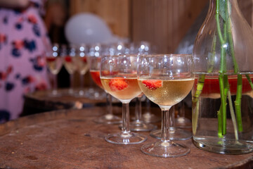 Champagne glasses with strawberries ready for the guests at a party
