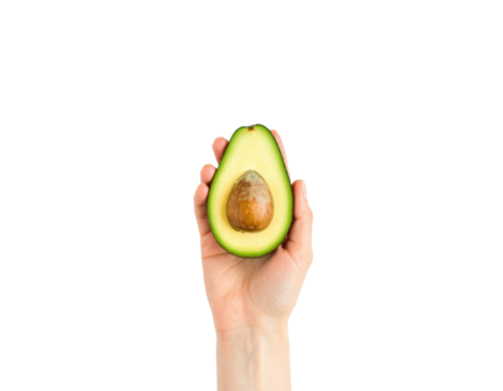 A human hand holding a ripe avocado half showcasing its creamy green flesh and brown seed isolated on transparent background. PNG die-cut for advertising