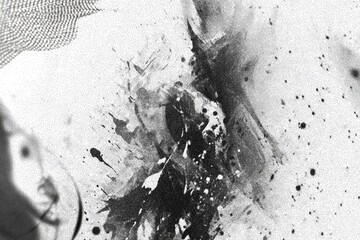 Abstract grayscale ink splatters on textured surface
