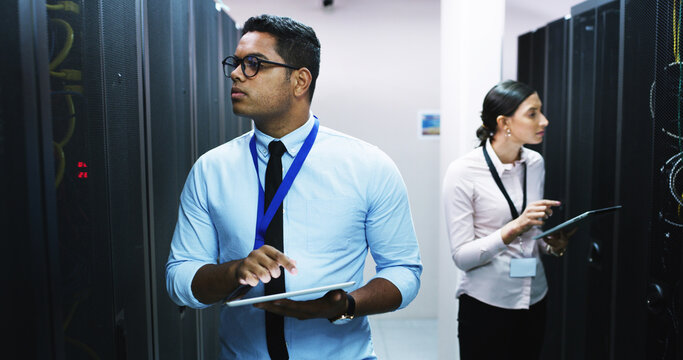 Man, woman and tablet in server room, storage and checklist on app for IT solution at company. People, cybersecurity team and system assessment with tech, review and information technology at agency - Powered by Adobe