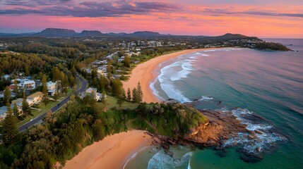 Panoramic coastal view at sunrise over a beach town.