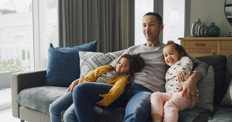 Children, father and smile on sofa with hug, bonding together and love for watching TV in home....