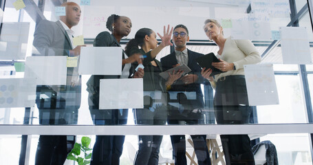 Planning, glass or business people in office with low angle for ideas, research or teamwork....
