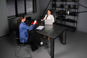 Brainstorming session in a modern office with two professionals collaborating
