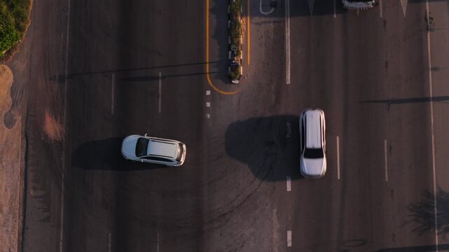 Aerial Top View of Car making U turn maneuver on Divided Highway at Designated Spot. Safety and Potential road Traffic Violations