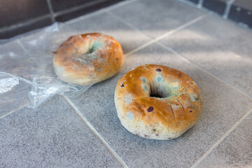 Moldy bagel on the  floor