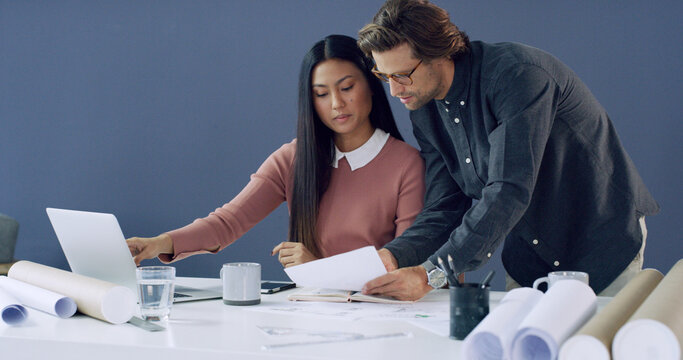 Architect, people and discussion with paperwork in office for design review, city planning or ideas. Space, teamwork or blueprint with laptop for architecture, property development or feedback report