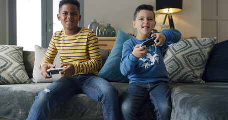 Playing, video games and children with controller, home and competitive for digital sport in...