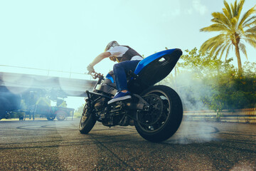 Moto stunt riding show on street.