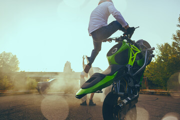 Moto stunt riding show on street.