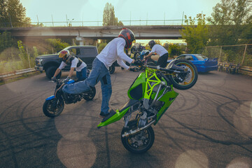 Moto stunt riding show on street.