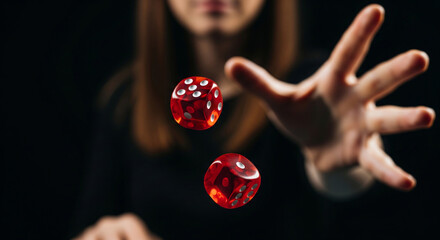 Two moving dice for playing dice game close-up, thrown by a blurred young woman's hand, isolated on black background. Concept of winning, jackpot, gambling addiction.