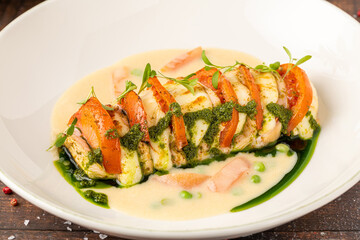 Stuffed chicken breast with tomato, mozzarella, cream and herb sauce