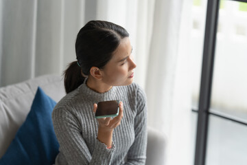 Asian woman using voice assistant on smartphone at home conversation with online assistant Voice chat bot conversational AI Modern Technologies.