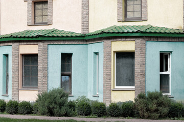 garden outdoor village house abandoned exterior space of different colors walls and dirty windows aged building background view