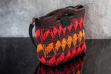 Women's handbag brown color hand knitted with orange-red weaves and long handle