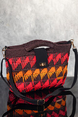 Women's handbag brown color hand knitted with orange-red weaves and long handle