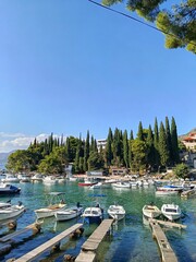 The sharm of a small harbor in Cavtat
A vertical glimpse of Cavtat’s peaceful marina, with boats...