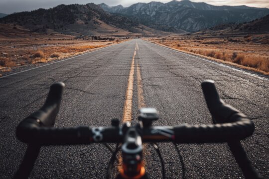 Road bike on empty highway, mountains in the distance
