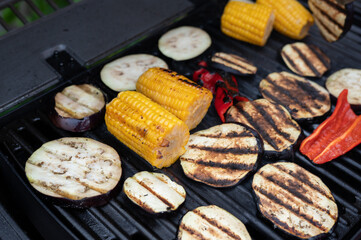Grilled vegetables on barbecue grill with corn, eggplant, and peppers
