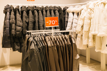 Winter coats sale discount on black and white outerwear displayed in store. Shopping Cart Day