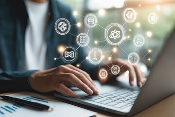 Close-up of person working on laptop with connected icons overlay