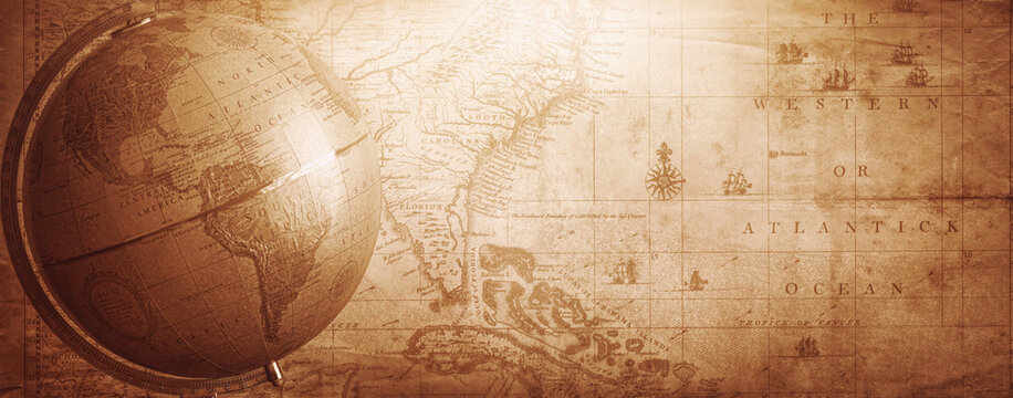Ancient globe on the old map background. Selective focus. Retro style. Science, education, travel, vintage background. History and geography team. - Powered by Adobe